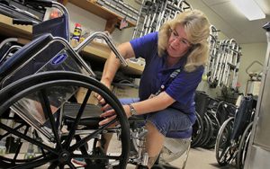 Shepherd Program woman fixing wheelchair